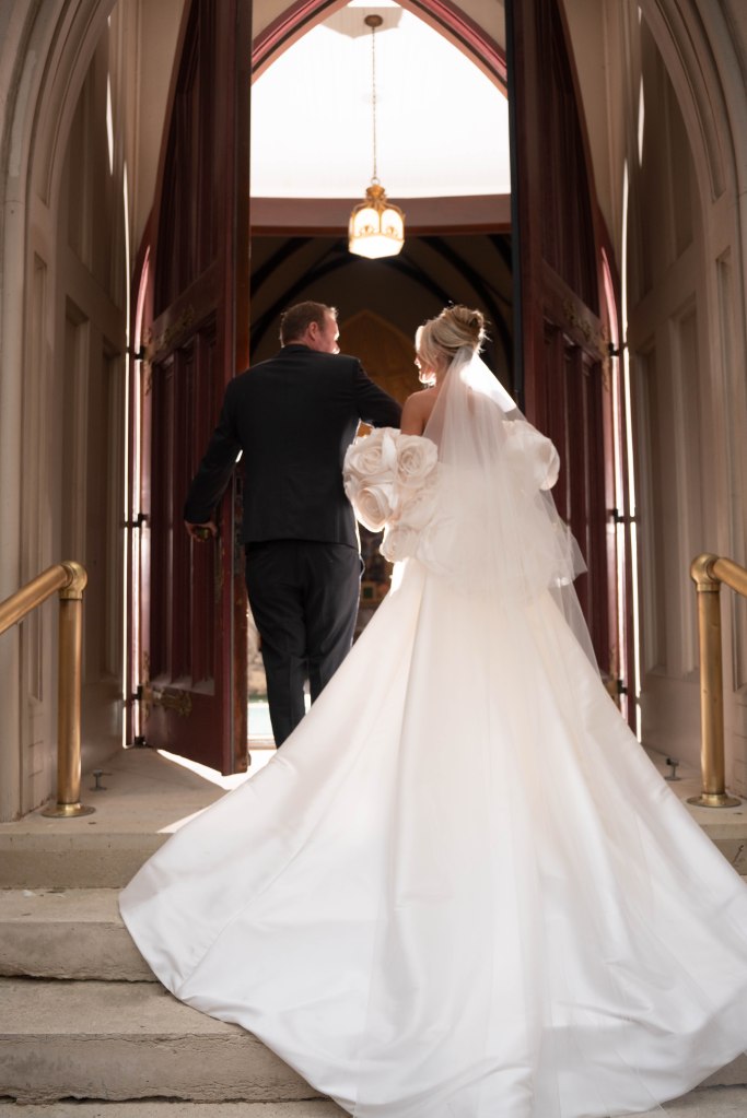 Bride walking into St. Patrick’s Cathedral with her father for the wedding ceremony