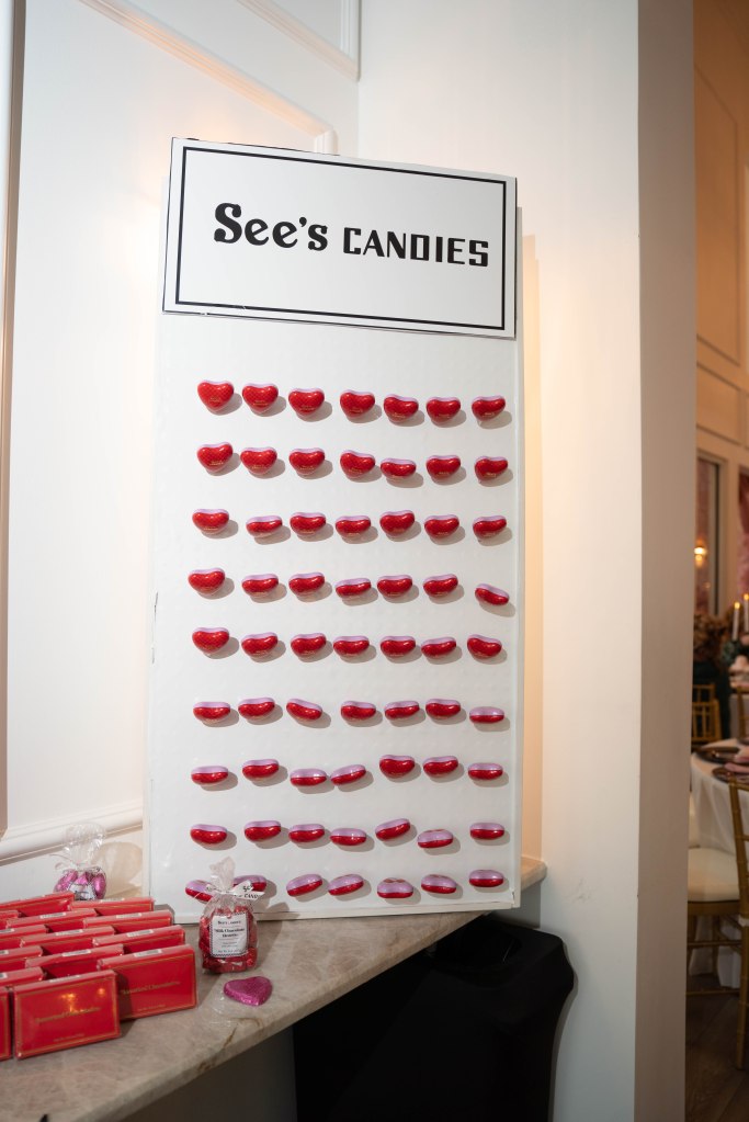 See’s Candies lollipops displayed on a peg board for wedding guest favors
