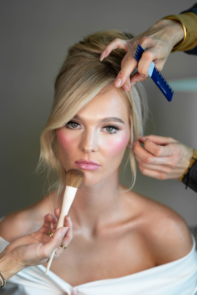 Elegant bride getting hair and makeup done, styled like a high-fashion Vogue editorial
