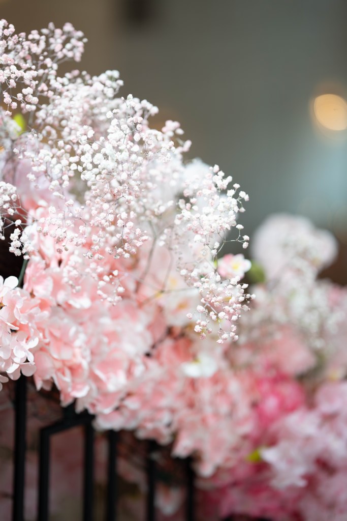 Detailed shot of pink-dyed baby’s breath floral arrangements
