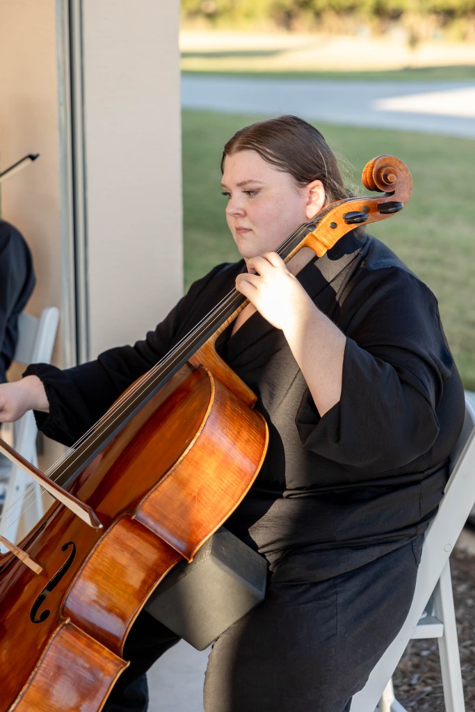 Cellist performing live music during a wedding ceremony creating an elegant and emotional atmosphere for guests and the couple.